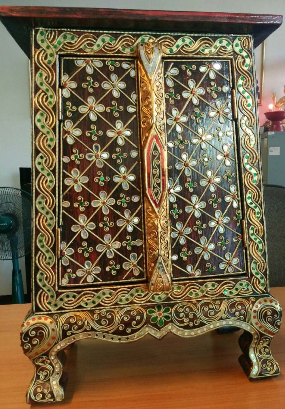 Thai patterned cabinet decorated with glass