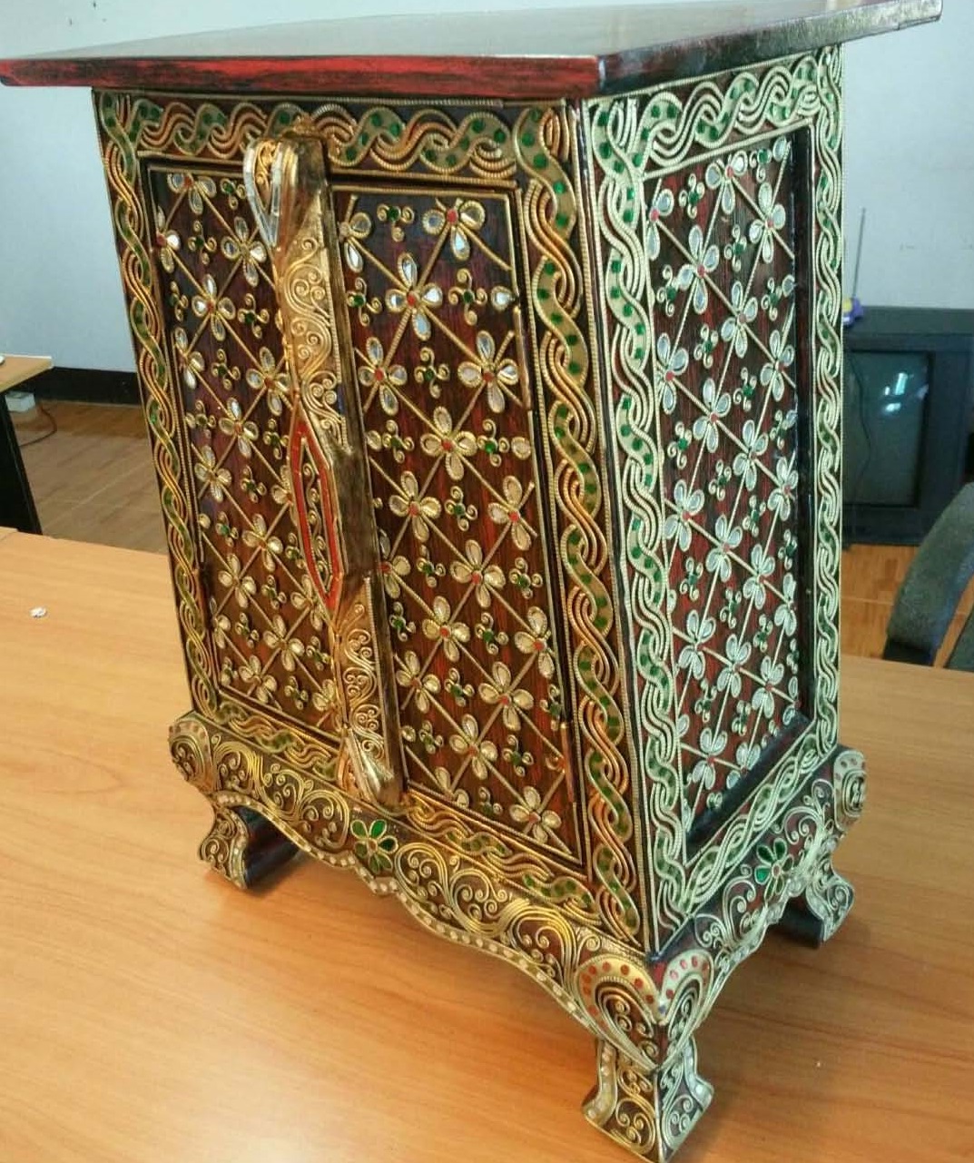 Thai patterned cabinet decorated with glass